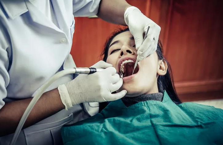 Dentist performing a general dentistry procedure for a patient in Weatherford, TX